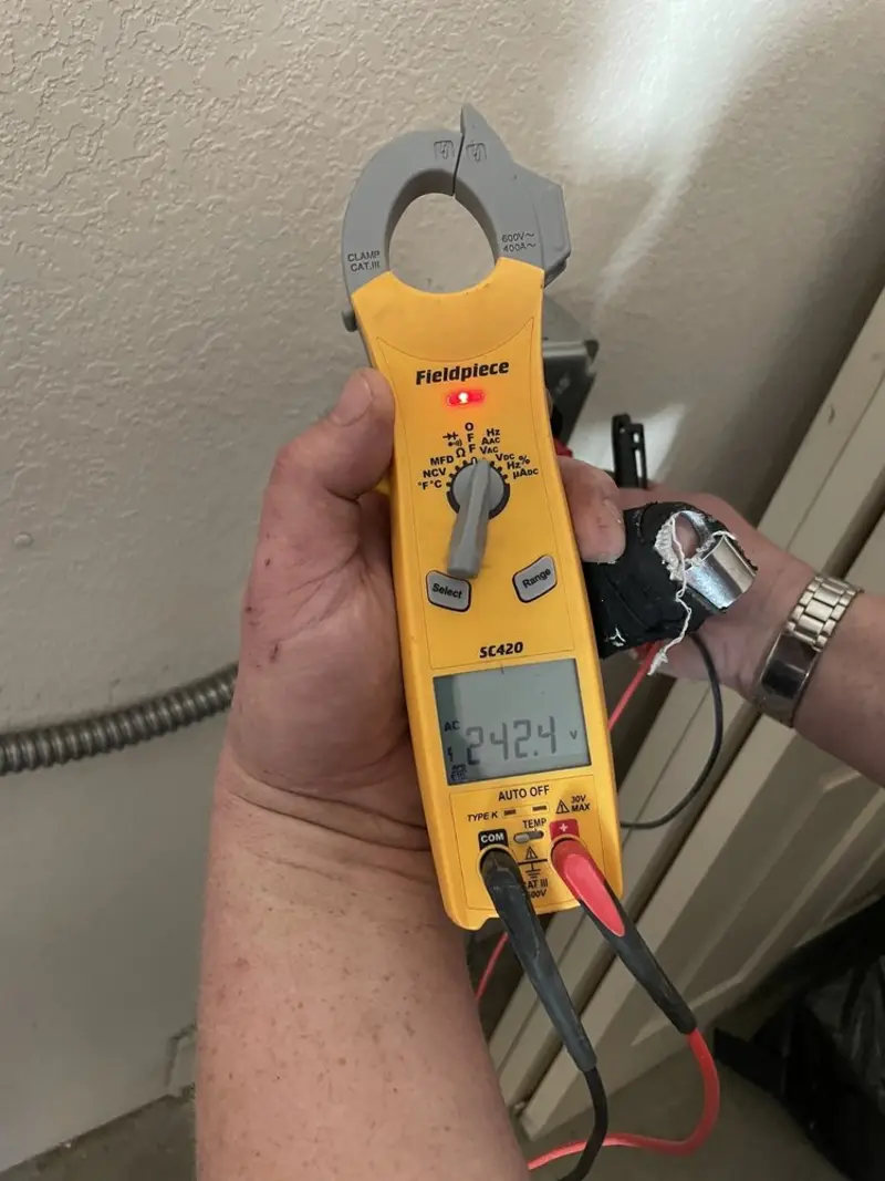 Voltage testing with clamp meter during Electrical Installation Services in Lockport